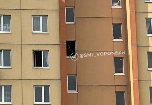 Экстренные службы съехались к одному из домов на улице 9 Января из-за мужчины, который с 7 часов сидит в оконном проёме